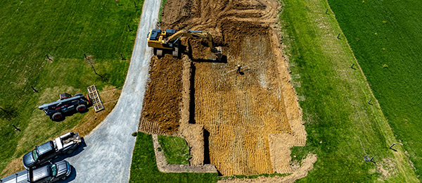 Workers preparing a site for a foundation Site Preparation