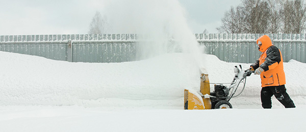 Worker using Snow Blowing machine Snow Blowing
