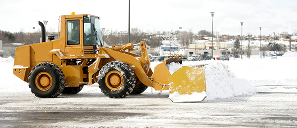 Loader removing snow from parking lot Snow Removal